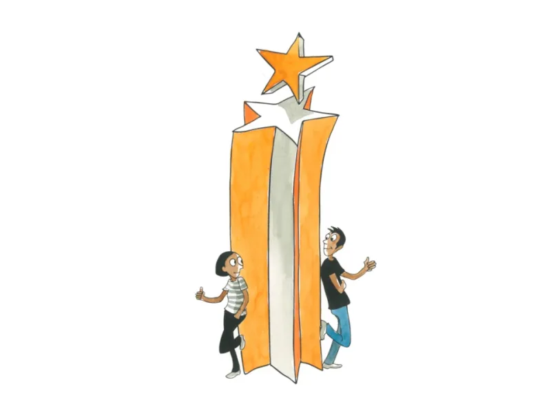 Children beside tall orange books topped with a star