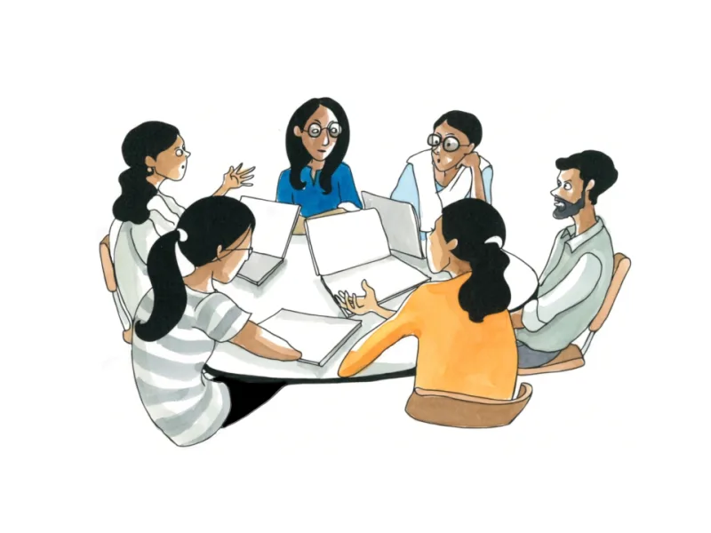 Learners discussing a shared project around a table